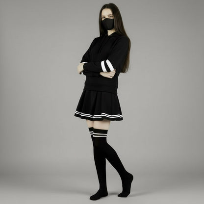 Person wearing a black hoodie with white stripes on a gray background