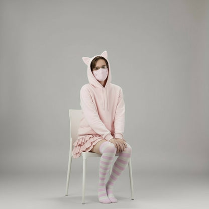 Femboy wearing a cute pink cat-themed hoodie and skirt set on a gray background