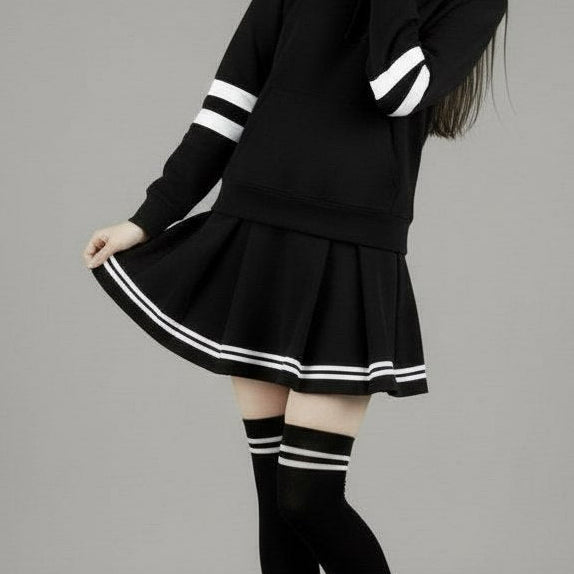 Person wearing a black outfit with white stripes on a gray background