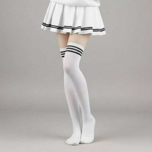 Person wearing a white hoodie, skirt, and stockings on a gray background